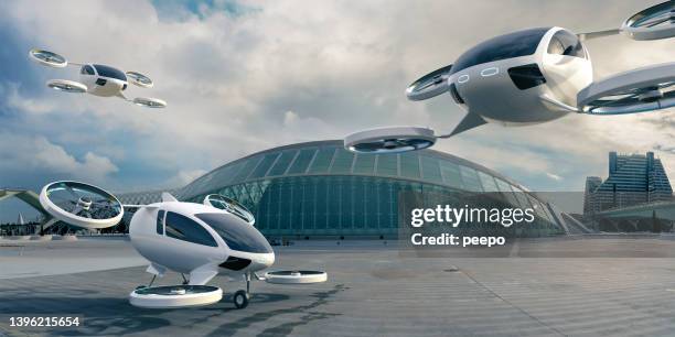 three evtol aircraft parked and in mid flight in front of terminal building - low carbon technology stockfoto's en -beelden