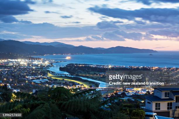 view of hutt river and wellington harbour at blue hour, looking south from hutt valley, wellington, nz - wellington harbour stock pictures, royalty-free photos & images