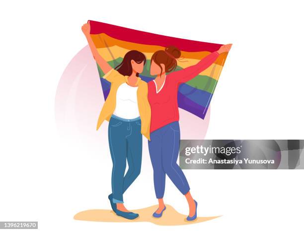 ilustraciones, imágenes clip art, dibujos animados e iconos de stock de pareja de lesbianas con la bandera del arco iris lgbt mostrando su apoyo a la igualdad de derechos para las minorías sexuales y la libertad de amor. chicas enamoradas abrazándose. ilustración vectorial estilo caricaturesco - mes del orgullo lgbt