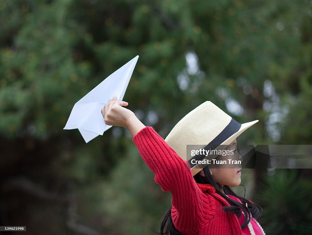Girl with paper airplane