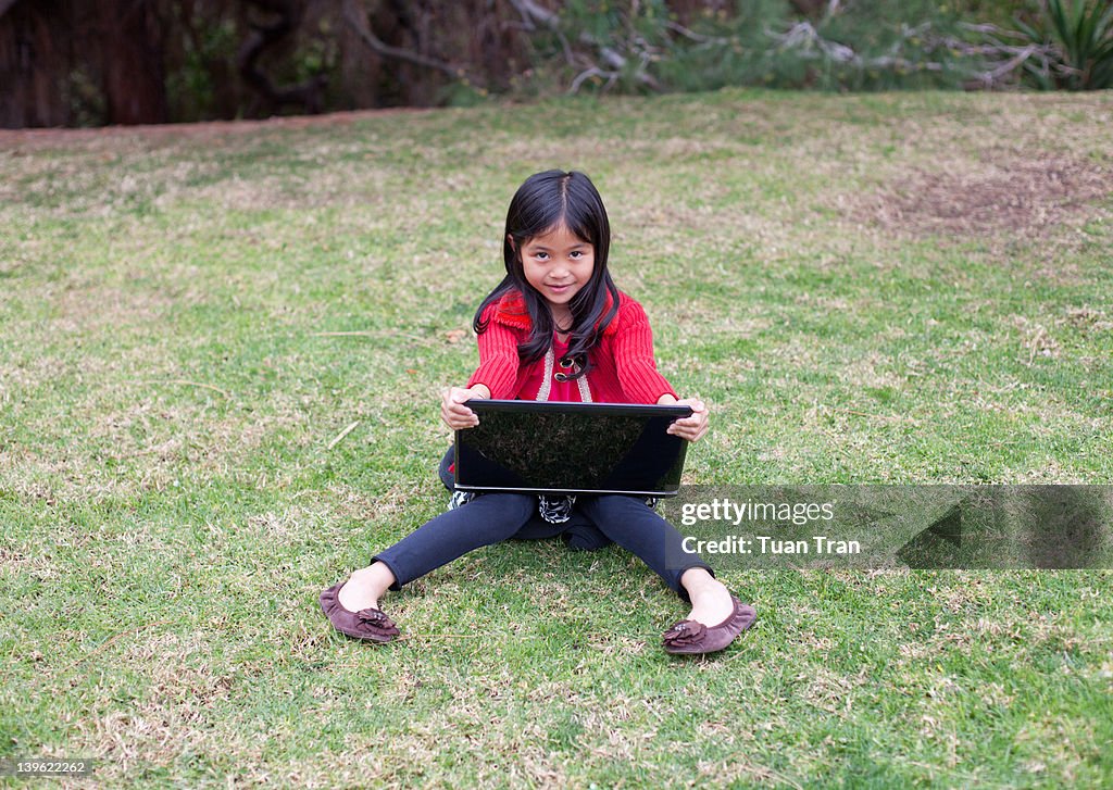 Young girl holding laptop