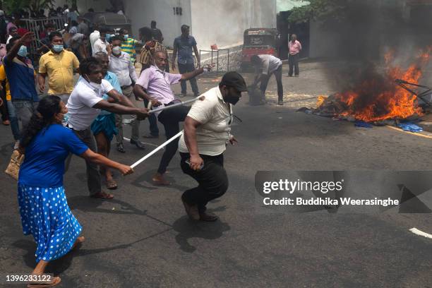 Pro-government protesters beat anti-government protester during a clash on May 09, 2022 in Colombo, Sri Lanka. Sri Lankan President Gotabaya...