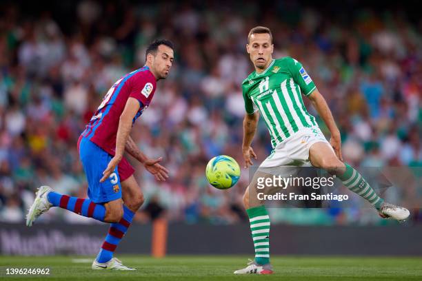 Sergio Canales of Real Betis competes for the ball with Sergio Busquets of FC Barcelona during the La Liga Santander match between Real Betis and FC...