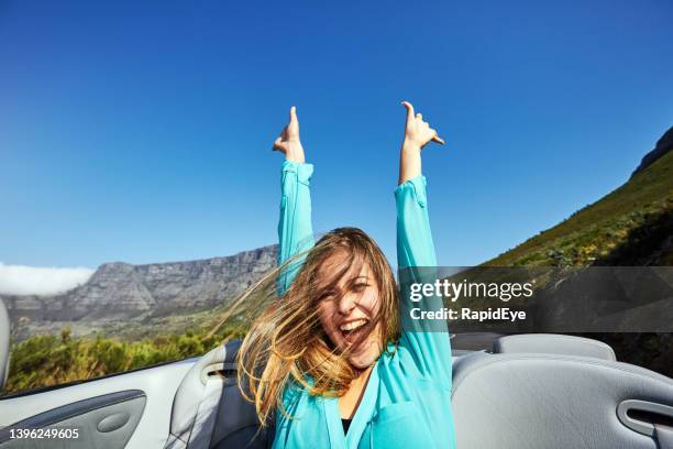 beautiful young woman tourist is happy riding in a convertible car near table mountain, cape town, south africa - toyota south africa motors stock pictures, royalty-free photos & images
