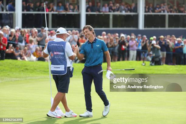 Thorbjorn Olesen of Denmark celebrates with caddie Dominic Bott after winning the Betfred British Masters hosted by Danny Willett at The Belfry on...