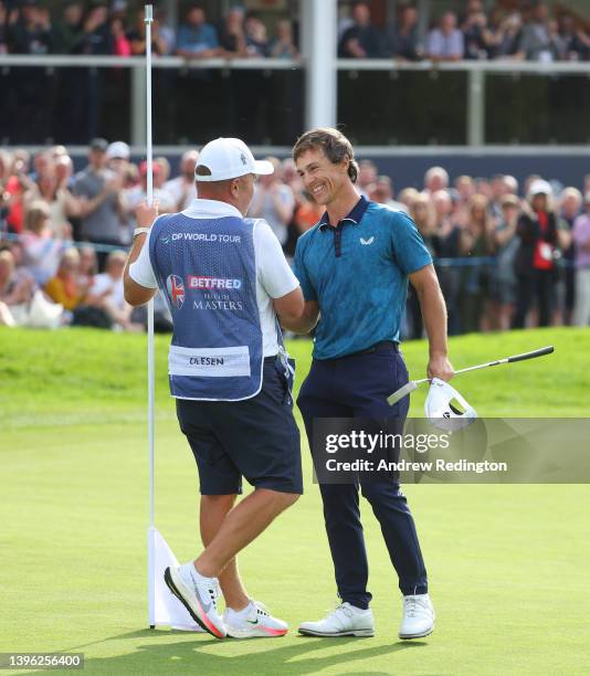 Thorbjorn Olesen of Denmark celebrates with caddie Dominic Bott after winning the Betfred British Masters hosted by Danny Willett at The Belfry on...