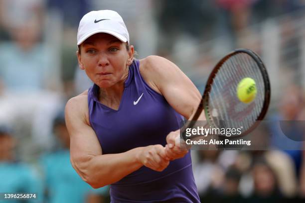 Simona Halep of Romania returns a backhand against Alize Cornet of France during their singles first round match in the Internazionali BNL D'Italia...