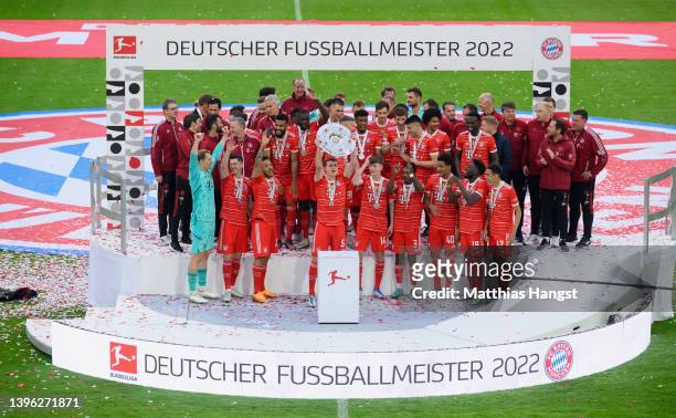 Benjamin Pavard of FC Bayern Muenchen lifts The Bundesliga Meisterschale trophy following their sides finish as Bundesliga champions during the...