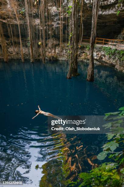 woman swimming in cenote in yucatan, mexico - tulum mexico 個照片及圖片檔