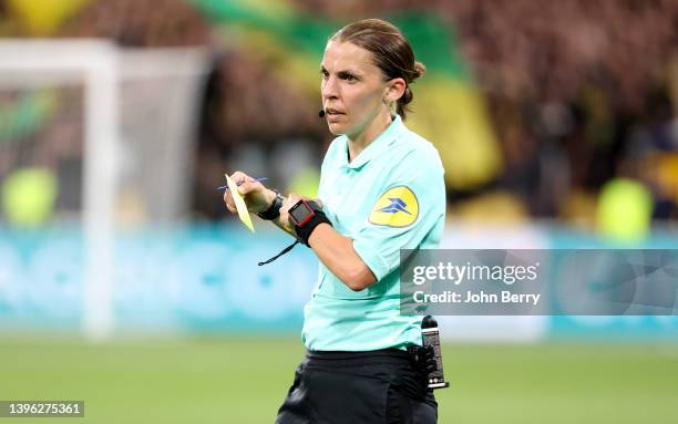 Referee Stephanie Frappart gives a yellow card during the French Cup Final between OGC Nice and FC Nantes at Stade de France on May 7, 2022 in...