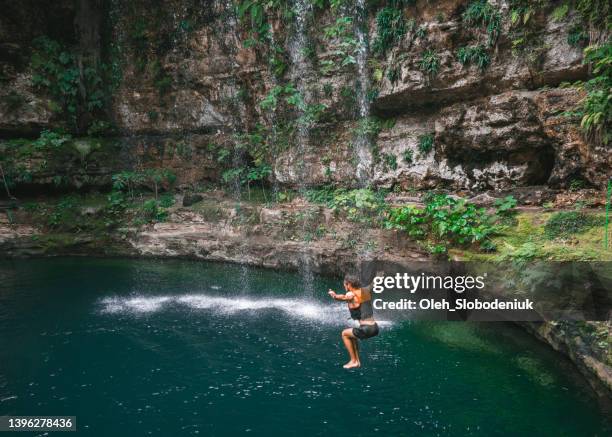 man jumping  into cenote in yucatan, mexico - mérida mexiko bildbanksfoton och bilder