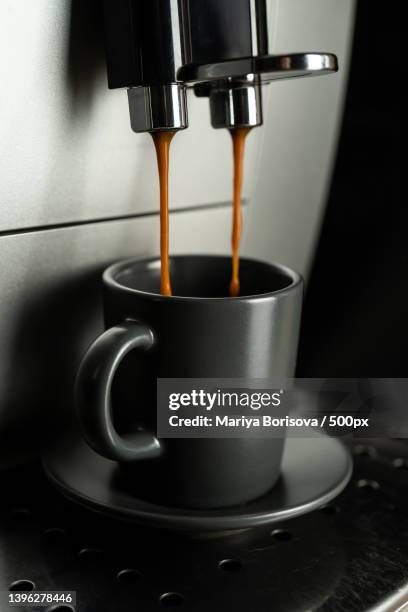 espresso is poured into an espresso cup from a home coffee machine - crema stock pictures, royalty-free photos & images