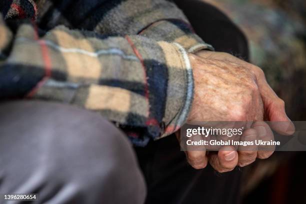 Close up view showing the hands of Vasyl Polianskyi, a resident of the Kyiv retirement home for veterans of labor, which shares his experiences,...