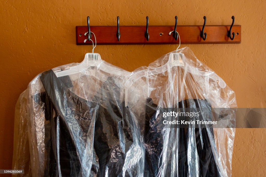 Garments hanging from wall hooks