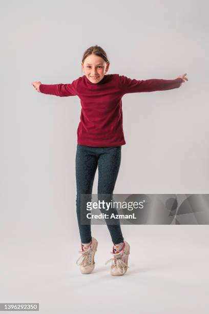 caucasian teenage girl standing on toes in studio - teen girls toes stock pictures, royalty-free photos & images