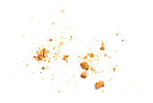 Scattered crumbs of vanilla chip butter cookies isolated on white background. Close-up view