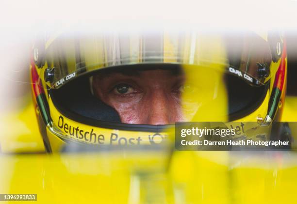 Jean Alesi of France, driver of the Benson and Hedges Jordan Honda Grand Prix Team Jordan EJ11 Honda V10 looks on from the cockpit during practice...