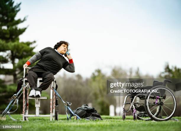 senior disabled latin lady practising shot put - shot put stock pictures, royalty-free photos & images