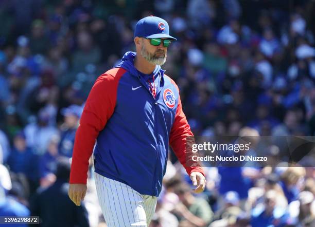 Manager David Ross of the Chicago Cubs walks to the dugout after making a pitching change during a game against the Los Angeles Dodgers at Wrigley...
