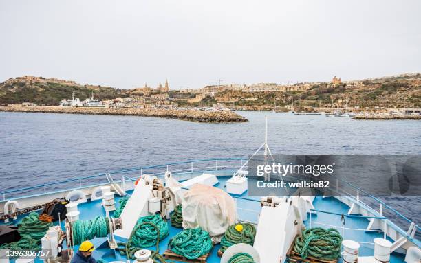car ferry approaches mgarr harbour - island of gozo mgarr stock pictures, royalty-free photos & images