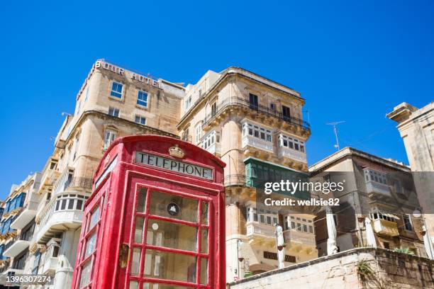 red phone box in valletta - britische kultur stock-fotos und bilder