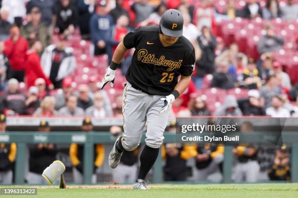 Yoshi Tsutsugo of the Pittsburgh Pirates jogs to first base after drawing a walk in the ninth inning against the Cincinnati Reds during game one of a...