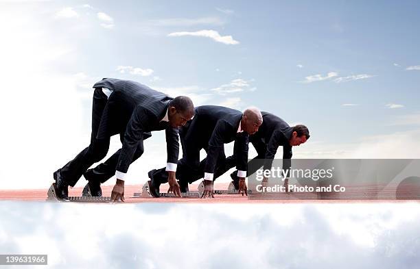 businessmen on start line of running track, - starting line stock pictures, royalty-free photos & images