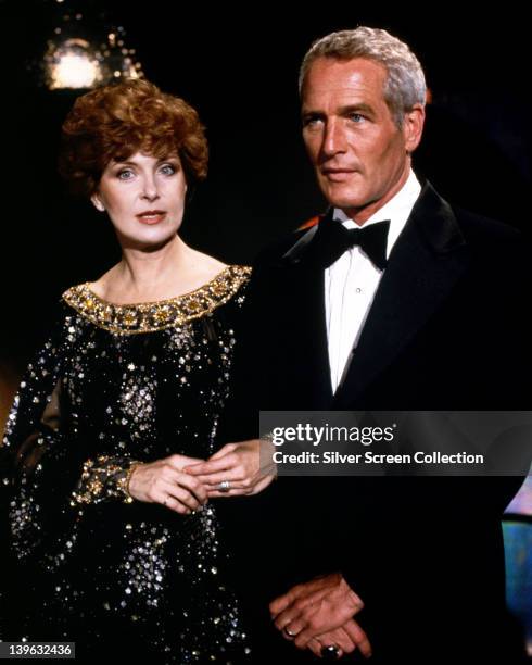 Joanne Woodward, US actress, wearing a black evening dress with gold trim, and Paul Newman , US actor, wearing a black tuxedo with a white shirt and...