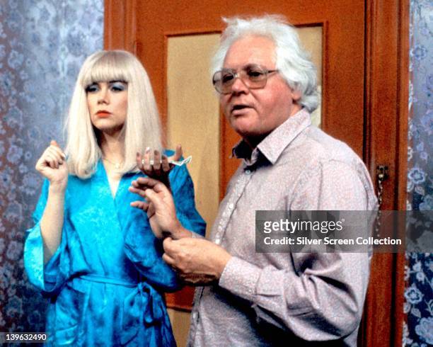 Kathleen Turner, US actress, wearing a blue silk dressing gown, and Ken Russell , British film director, on the set of the film, 'Crimes of Passion',...