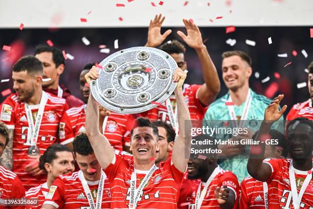 Robert Lewandowski of Munich lifts The Bundesliga Meisterschale trophy following their sides finish as Bundesliga champions after the Bundesliga...
