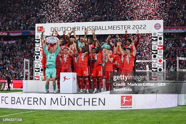 Players of Bayern Munich celebrating winning the championship with the Bundesliga Meisterschale after the Bundesliga match between FC Bayern München...