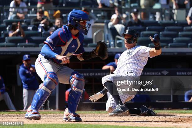 Aaron Judge of the New York Yankees slides safely into home during the eighth inning of the game against the Texas Rangers at Yankee Stadium on May...