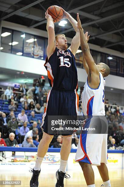 Joe Willman of the Bucknell Bison takes a shot over Charles Hinkle of the American Eagles during a college basketball game on February 23, 2012 at...