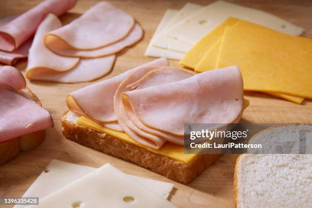 preparing a monte cristo sandwich - een broodje smeren stockfoto's en -beelden