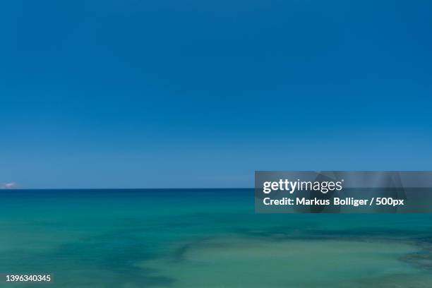 scenic view of sea against clear blue sky - türkis blau - fotografias e filmes do acervo