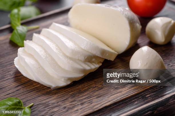 tasty fresh mozzarella cheese for making caprese salad - mozzarella fotografías e imágenes de stock