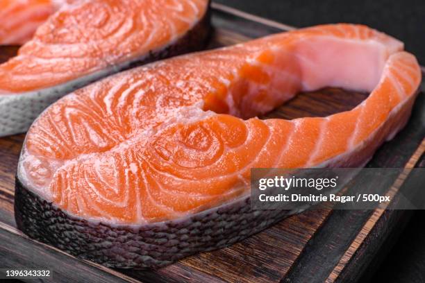 fresh raw salmon steak with spices and herbs - trout stock photos et images de collection