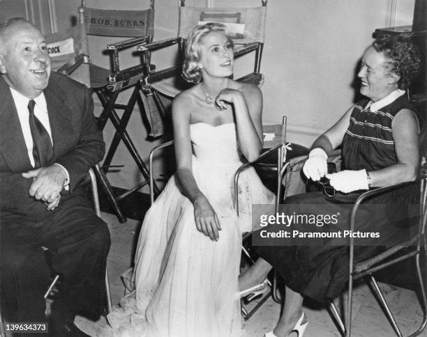 American actress Grace Kelly on the set of 'To Catch a Thief' with director Alfred Hitchcock and his wife Alma Reville at Paramount Studios,...
