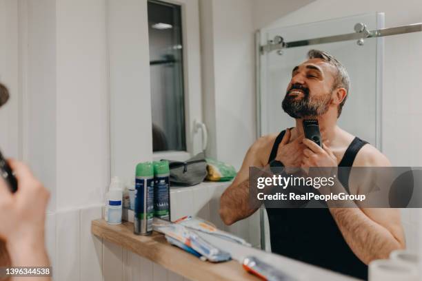 handsome mature man shaving in bathroom - shaving tools stock pictures, royalty-free photos & images