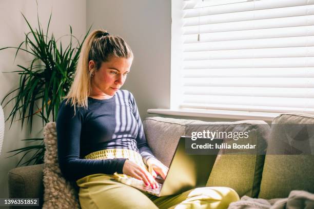 young woman using laptop - showus business stock pictures, royalty-free photos & images