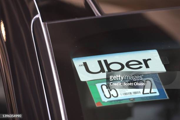 An Uber driver arrives to pick up a passenger at Midway International Airport on May 09, 2022 in Chicago, Illinois. Uber plans to cut spending and...