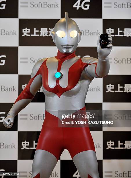Model dressed as the fictional action character Ultraman displays the "Ultra Wi-Fi 4G" Wi-Fi router, featuring a maximum reception speed of 110...