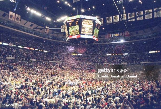 Players and fans converge on the floor of the United Center to celebrate after the Chicago Bulls defeat the Utah Jazz 90-86 in game 6 to win the 1997...