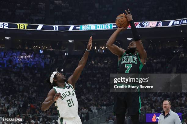 Jaylen Brown of the Boston Celtics takes a three point shot over Jrue Holiday of the Milwaukee Bucks during the first quarter of Game 4 of the...