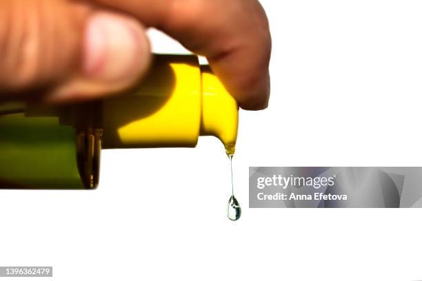 human hand squeezes a drop of moisturizing lotion from a bottle dispenser against white background. concept of beauty procedures and body care. polyglutamic acid is a new hyaluronic acid. macro photography - sanitizing products stock pictures, royalty-free photos & images