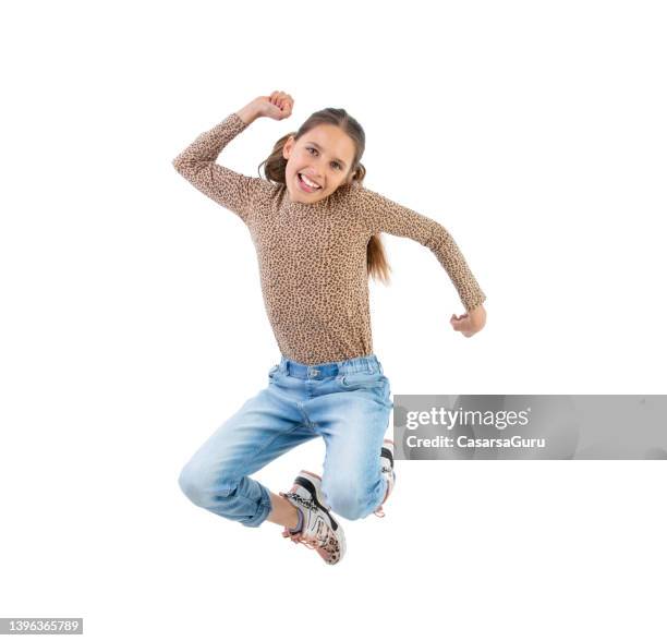 excited teen girl jumping against white background - animal pattern stock pictures, royalty-free photos & images