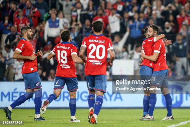 Manuel Monzeglio of Nacional celebrates with teammates after scoring the first goal of his team during a match between Nacional and Fenix as part of...