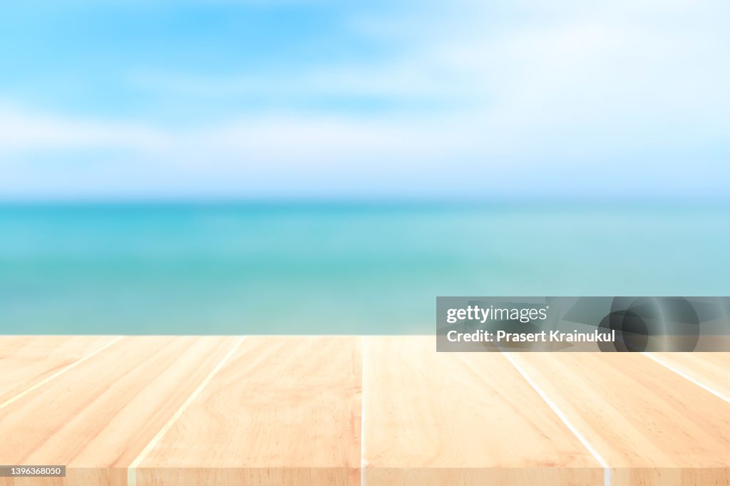 Top of the wood table in front of the white beach background