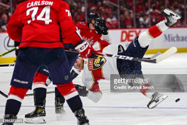 Sam Bennett of the Florida Panthers is checked by T.J. Oshie of the Washington Capitals during the third period in Game Four of the First Round of...