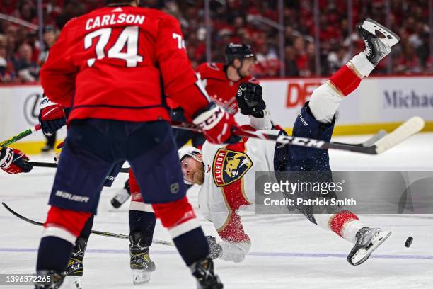 Sam Bennett of the Florida Panthers is checked by T.J. Oshie of the Washington Capitals during the third period in Game Four of the First Round of...